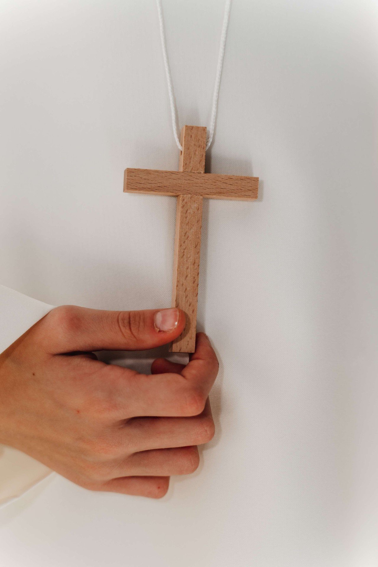 Croce in legno tra le mani